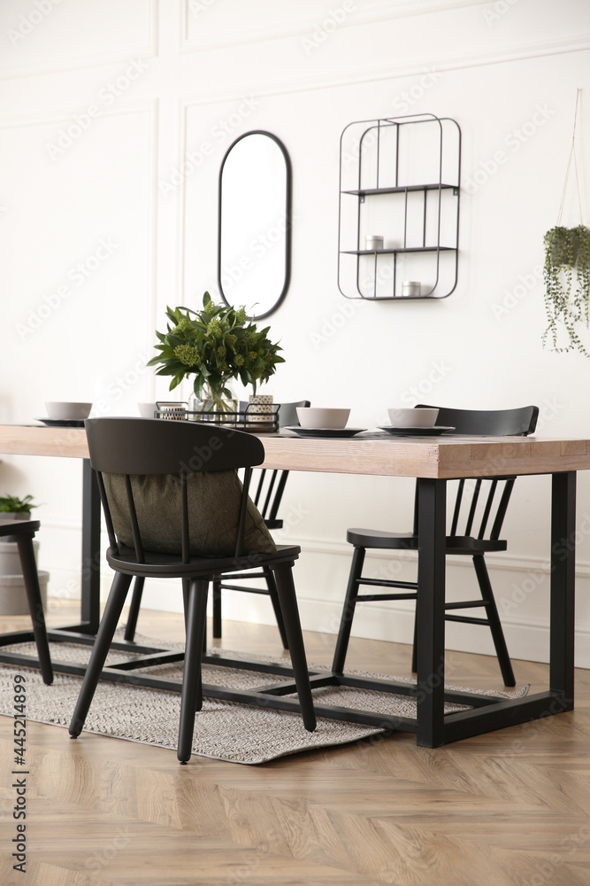 Fototapeta premium Stylish wooden dining table and chairs in room. Interior design