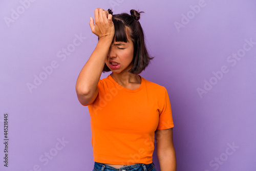 Young mixed race woman isolated on purple background forgetting something, slapping forehead with palm and closing eyes.