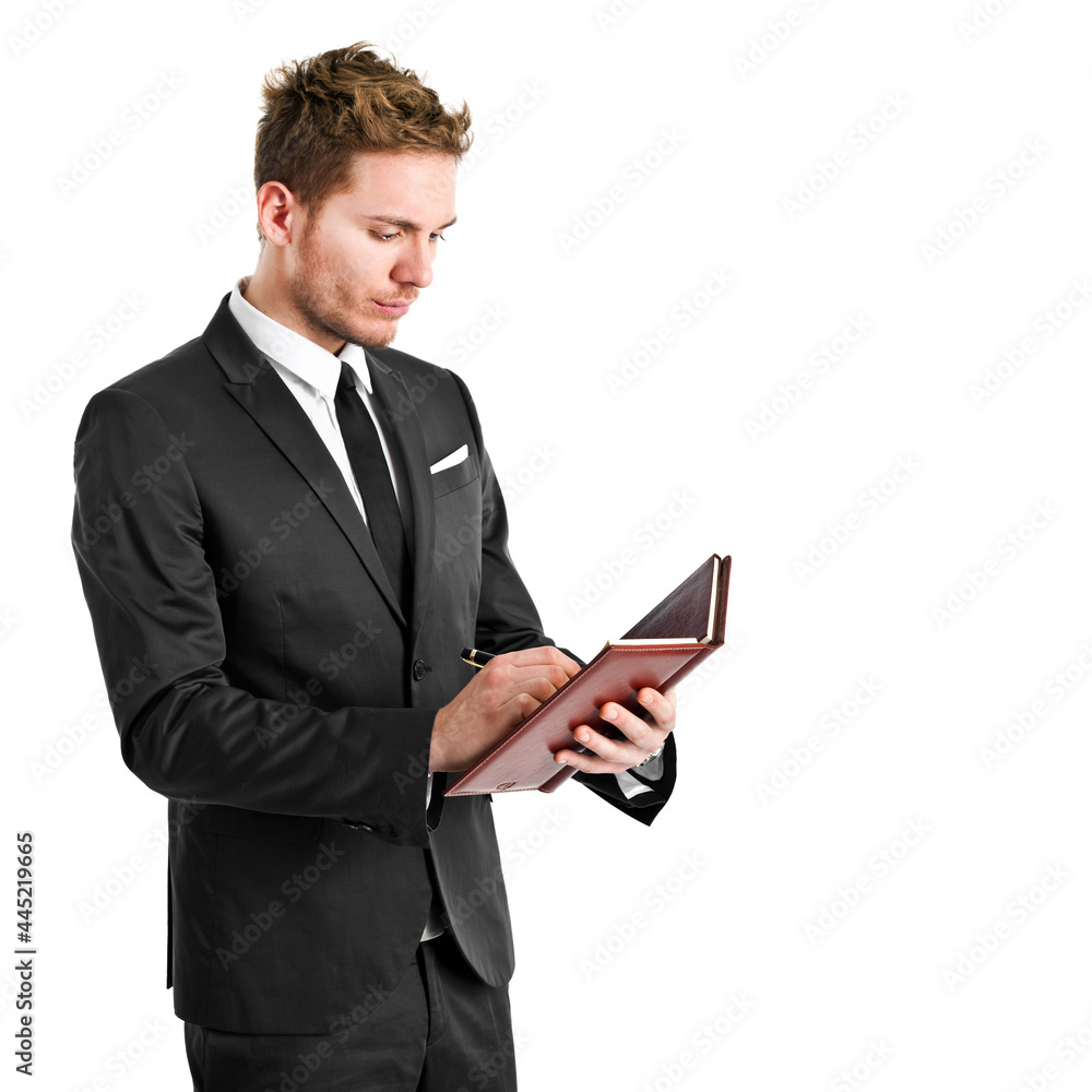 Young businessman writing on his agenda Young businessman writing on his agenda