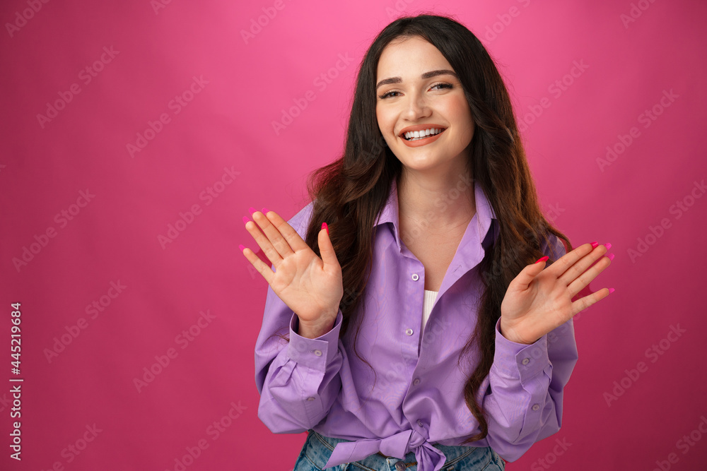 Young happy woman smiling over pink background Young happy woman smiling over pink background
