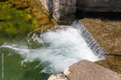 Mountain river cascades. Noisy waterfall. Clear turquoise water. Beautiful landscape.