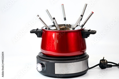 Red electric fondue on white background, isolate © AlexLit