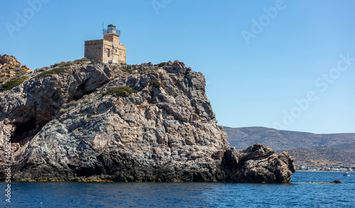 Lighthhouse building on a rocky cliff. Ios island Greece. Cyclades