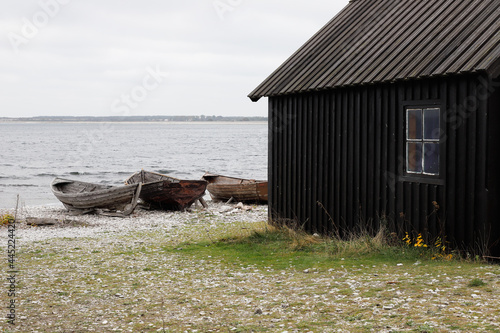 Obraz na płótnie Old shed and boats at the historic Helgumannen fishing station located on the Faro island in the Swedish province of Gotland. w salonie