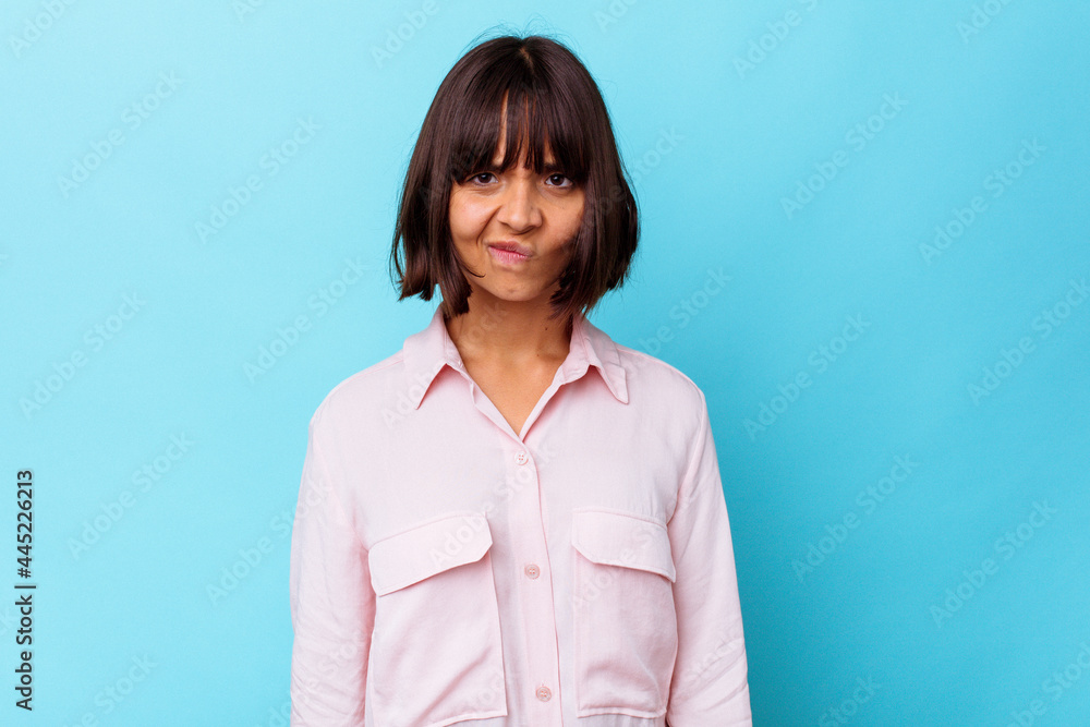 Young mixed race woman isolated on blue background sad, serious face, feeling miserable and displeased. Young mixed race woman isolated on blue background sad, serious face, feeling miserable and displeased.