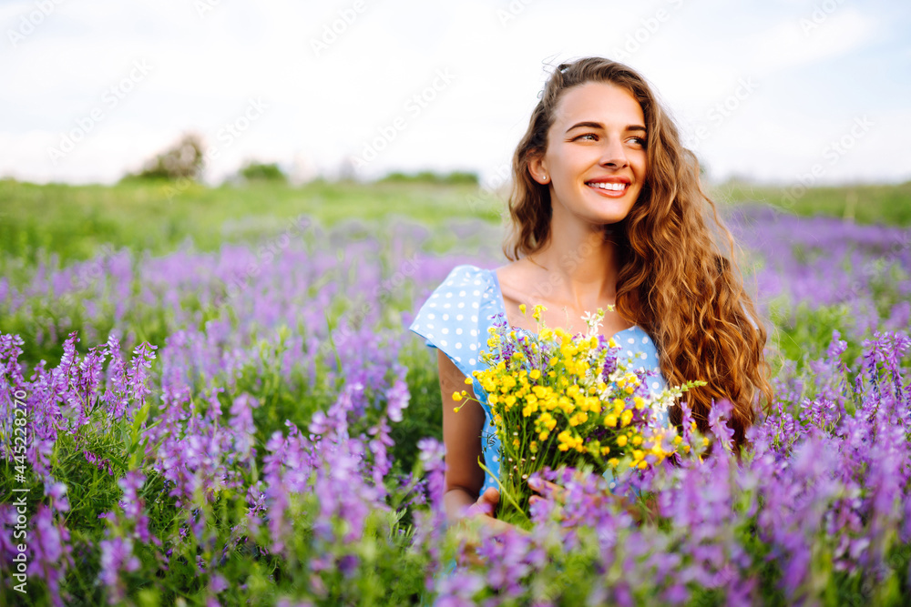 Young woman in stylish summer dress feeling free in the field with flowers in sunshine. Nature, vacation, relax and lifestyle. Summer landscape. Young woman in stylish summer dress feeling free in the field with flowers in sunshine. Nature, vacation, relax and lifestyle. Summer landscape.