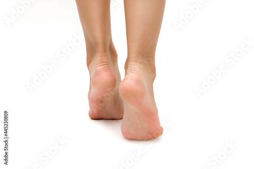 women's beautiful well-groomed feet, heels close-up on a white isolated background. the concept of foot care, prevention of calluses and cracks on the feet