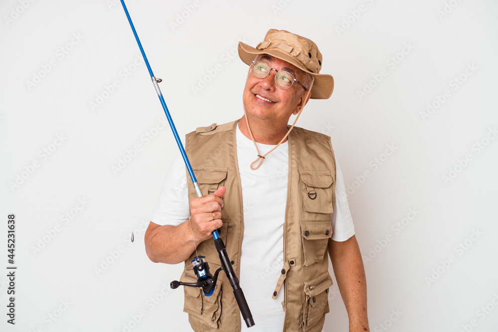 Senior american fisherman holding rod isolated on white background dreaming of achieving goals and purposes Senior american fisherman holding rod isolated on white background dreaming of achieving goals and purposes