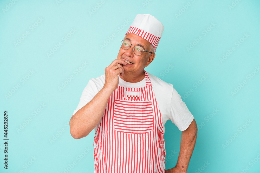 Senior american ice cream man woman holding isolated on blue background relaxed thinking about something looking at a copy space. Senior american ice cream man woman holding isolated on blue background relaxed thinking about something looking at a copy space.