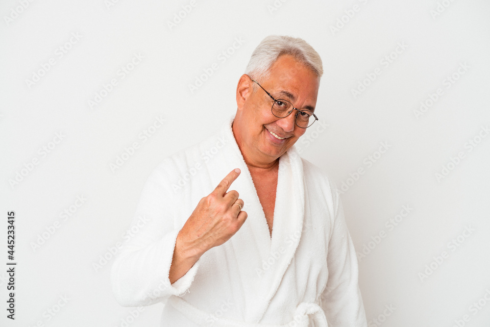 Senior american man wearing bathrobe isolated on white background pointing with finger at you as if inviting come closer. Senior american man wearing bathrobe isolated on white background pointing with finger at you as if inviting come closer.