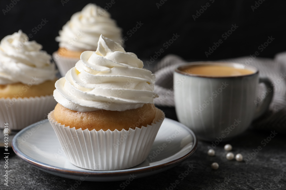 Delicious cupcakes with cream on grey table, closeup Delicious cupcakes with cream on grey table, closeup
