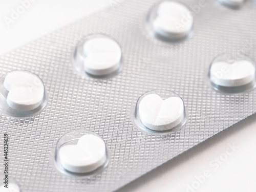 Heart-shaped white pills in blister package
