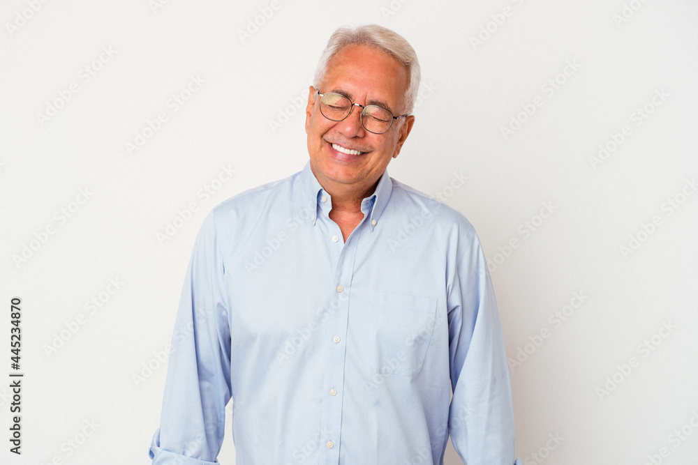 Senior american man isolated on white background laughs and closes eyes, feels relaxed and happy. Senior american man isolated on white background laughs and closes eyes, feels relaxed and happy.