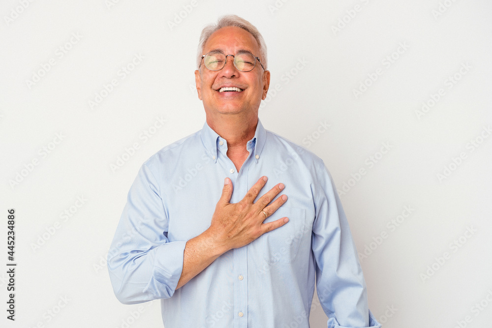 Senior american man isolated on white background laughs out loudly keeping hand on chest. Senior american man isolated on white background laughs out loudly keeping hand on chest.