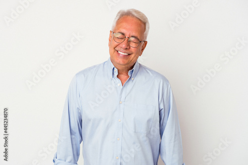 Senior american man isolated on white background laughs and closes eyes, feels relaxed and happy. © Asier