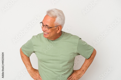 Senior american man isolated on white background laughs happily and has fun keeping hands on stomach.