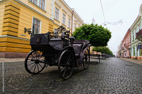 Chernivtsi, Ukraine-May 14, 2021:Scenic foggy morning landscape view of famous pedestrian Olga Kobylianska street. Iron coach is famous travel destination in the city. Travel and tourism concept