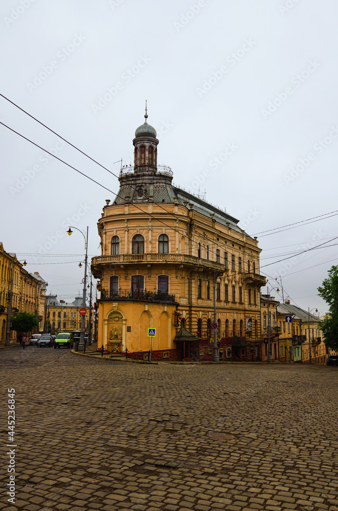 Chernivtsi, Ukraine-May 14, 2021:Picturesque foggy landscape of city. Ancient building called Ship House is one of the famous travel destination in the city. Spring misty morning