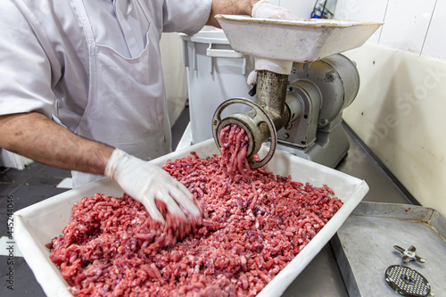 Konstfotografi Meat being ground in a meat grinder. In a restaurant