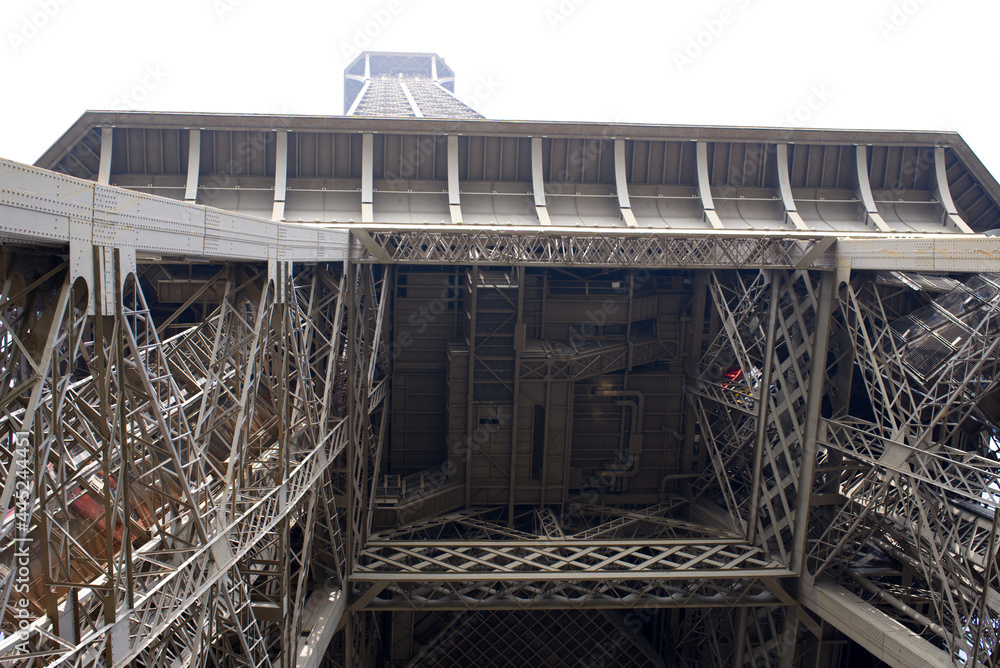 Fototapeta premium Close-up of Eiffel tower early in the morning at springtime with misty sky background. Photo taken May 1st, 2019, Paris, France.