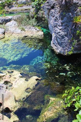 River between beautiful rocks at Xcaret park. Xcaret is famous ecotourism park on the mexican Riviera Maya  Quintana Roo  Yucatan  Mexico.