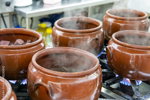 Ceramic pot with feijoada, typical Brazilian food. In a restaurant in Brazil