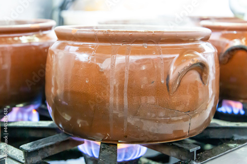 Ceramic pot with feijoada, typical Brazilian food. In a restaurant in Brazil
