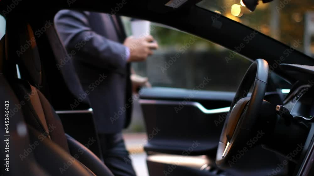 Animation of red shapes over man sitting in car Animation of red shapes over man sitting in car