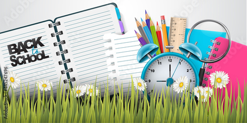 School banner or header. Education design concept with college stationery supplies for students and teachers behind green grass. Realistic 3d vector illustration.