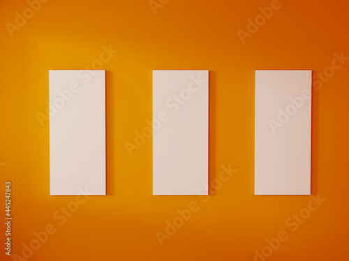 Blank picture frame mock up on the orange wall. 3d rendering.