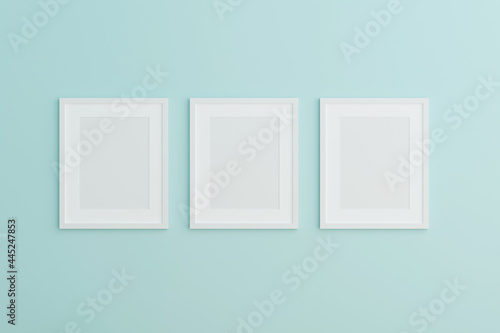 Blank picture frame mock up on the blue wall. 3d rendering.