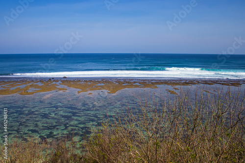 Aerial view of Gunung Payung Beach at low tide  Bali  Indonesia. Beautiful secret beach with turquoise water not far from another famous Pandawa beach. Indian ocean  travel and vacation concept