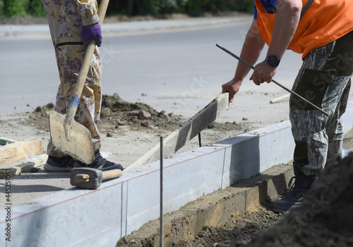 Installation of concrete blocks in cement, road construction.