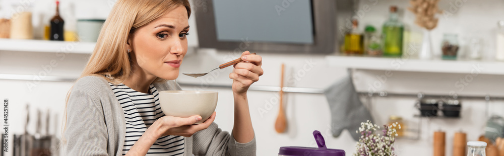 blonde woman having breakfast in kitchen, banner blonde woman having breakfast in kitchen, banner