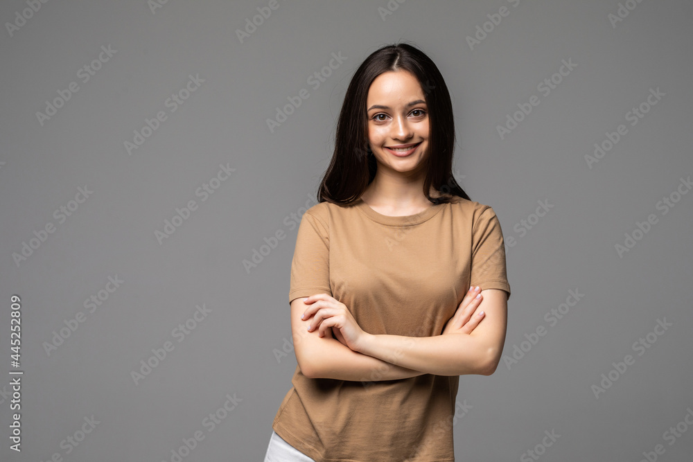 Portrait of a happy woman standing with arms folded on a white background Portrait of a happy woman standing with arms folded on a white background