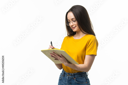 Pretty woman holding diary in hands having creative idea noticing at on paper on white background photo