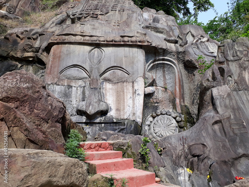 Goddess in the hills of Unakoti carved on a rock in India photo