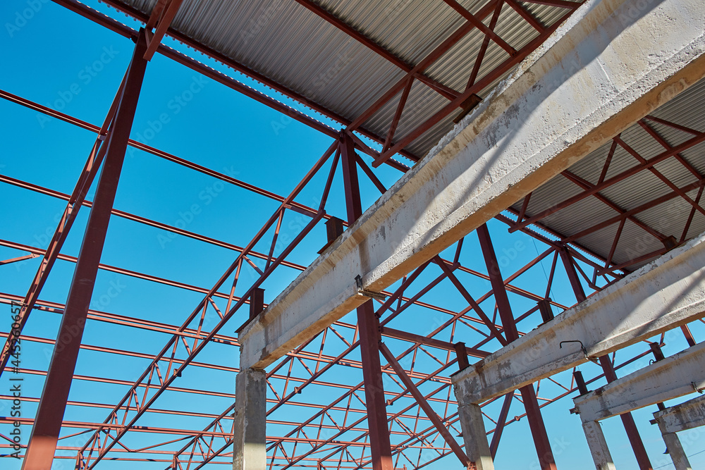 Steel construction on an industrial construction site with a clear blue sky