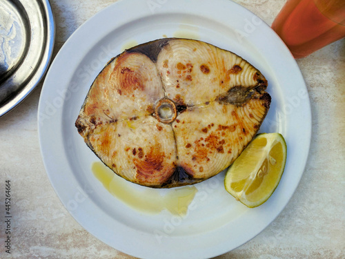 Seafood with a slice of lemon on a plate. A dinner dish at a restaurant on the island of Santa Cruz de Tenerife, Spain