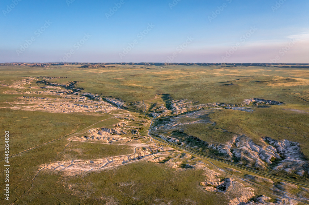 Naklejka premium morning light over arroyo and badlands in Pawnee National Grassland in northern Colorado, early summer scenery aerial view of Main Draw area