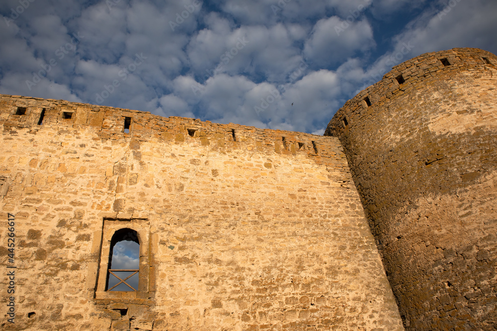 stone wall of the fortress or castle against the blue sky