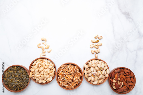 Different kind of nuts in wooden bowls