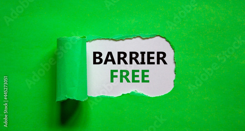 Barrier free symbol. Words 'Barrier free' appearing behind torn green paper. Beautiful green background. Business, diversity, inclusion, belonging and barrier free concept, copy space.