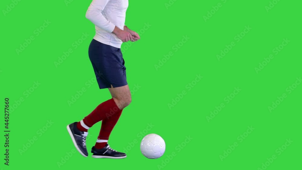Soccer ball being kicked by footballer on a Green Screen, Chroma Key