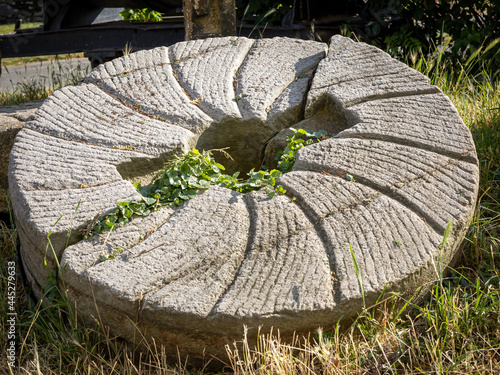 Grinding stone from an old windmill, broken in two pieces. Sobotka, Poland. photo