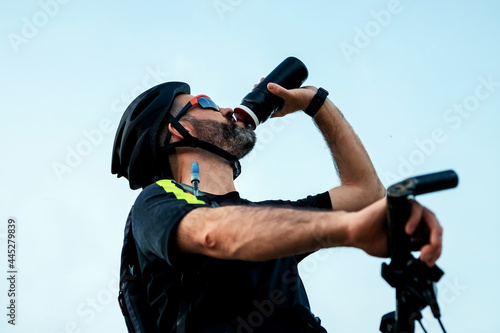 cyclist drinking water after exercise
