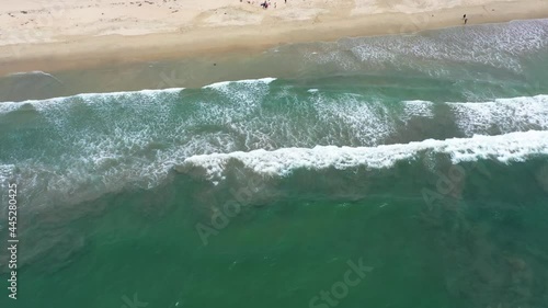 Aerial drone view looking down on waves rolling in from the pacific ocean at Huntington Beach California_04