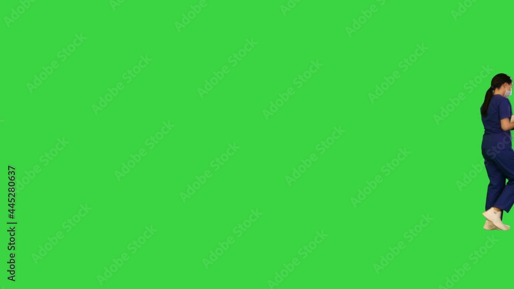 Young indian female doctor walks with notebook on a Green Screen, Chroma Key. Young indian female doctor walks with notebook on a Green Screen, Chroma Key.