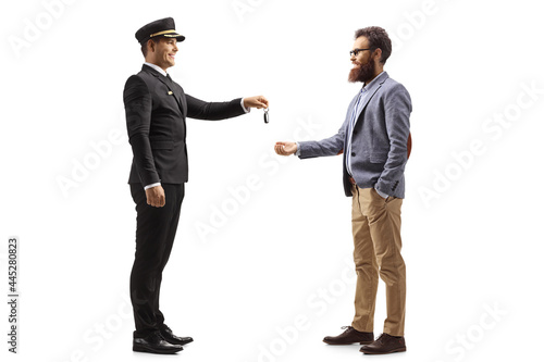 Chauffeur giving car keys to a bearded man