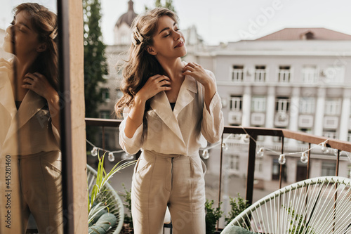 Papier peint Cheerful girl in beige blouse resting on terrace